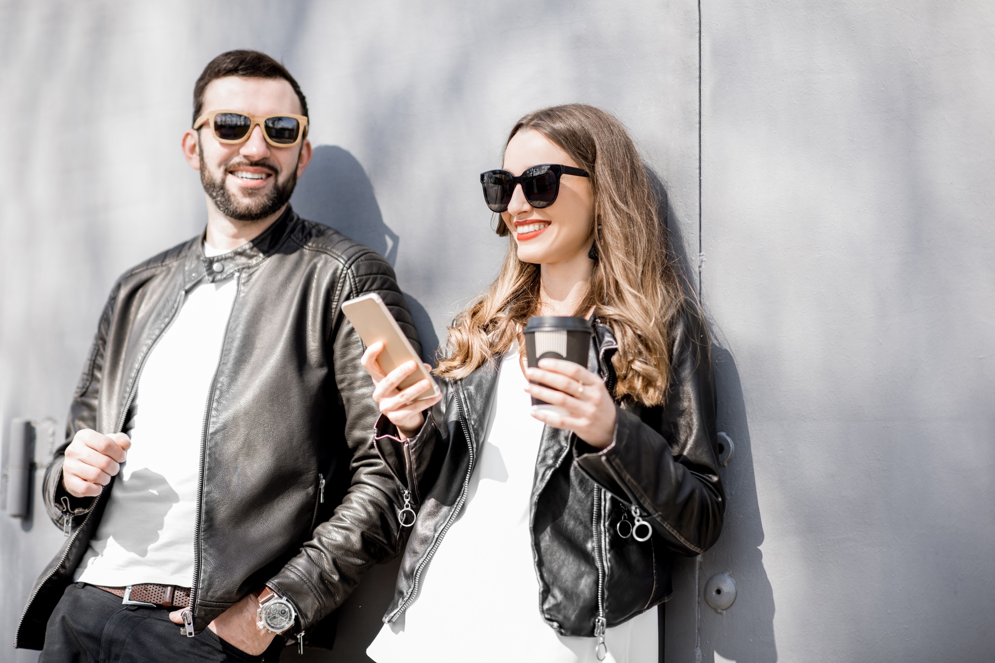 Stylish couple on the grey background