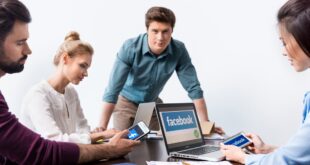 Young businesspeople using digital devices with facebook logo icons on screens